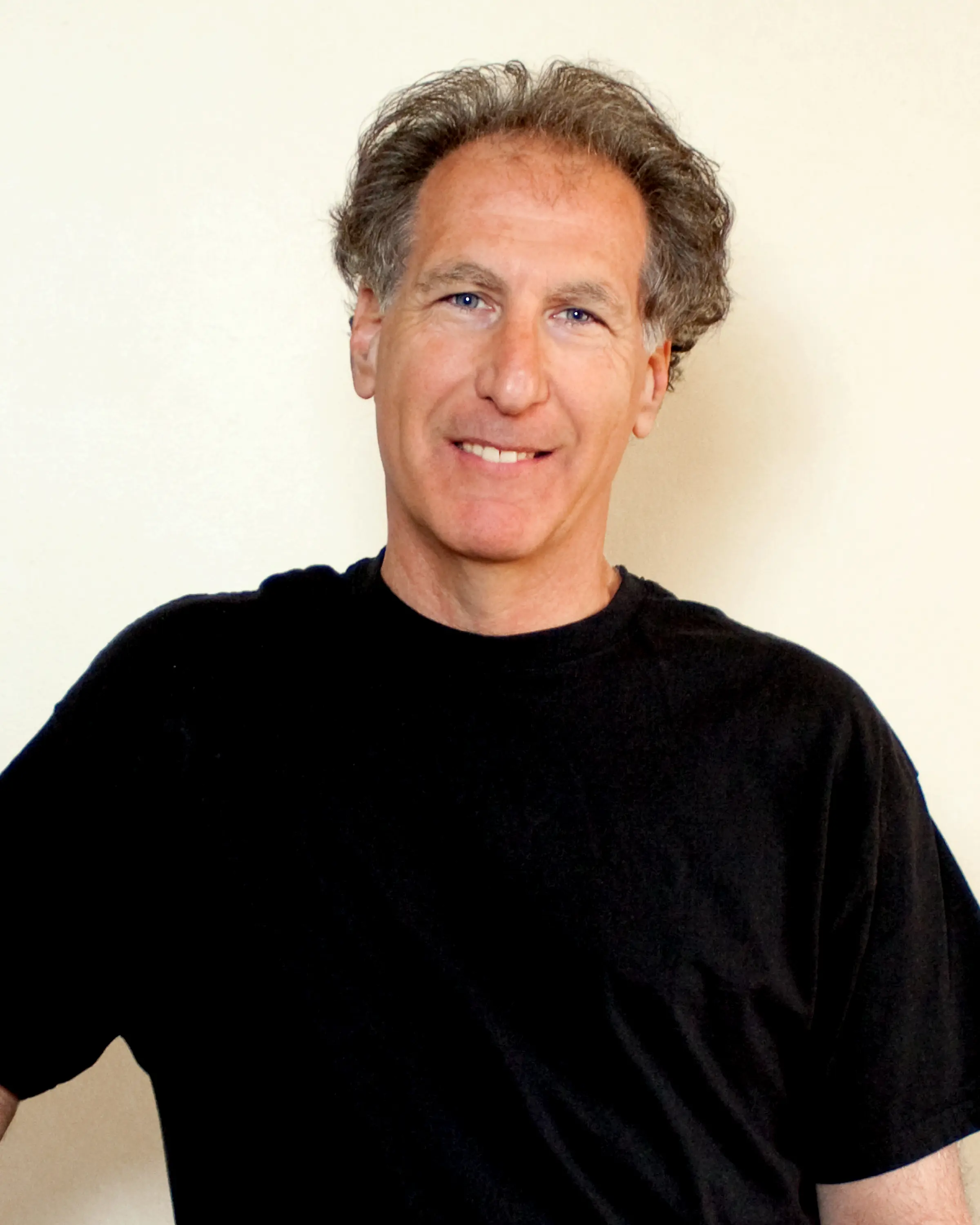 Portrait photo of Steve Feld in black t-shirt and white background